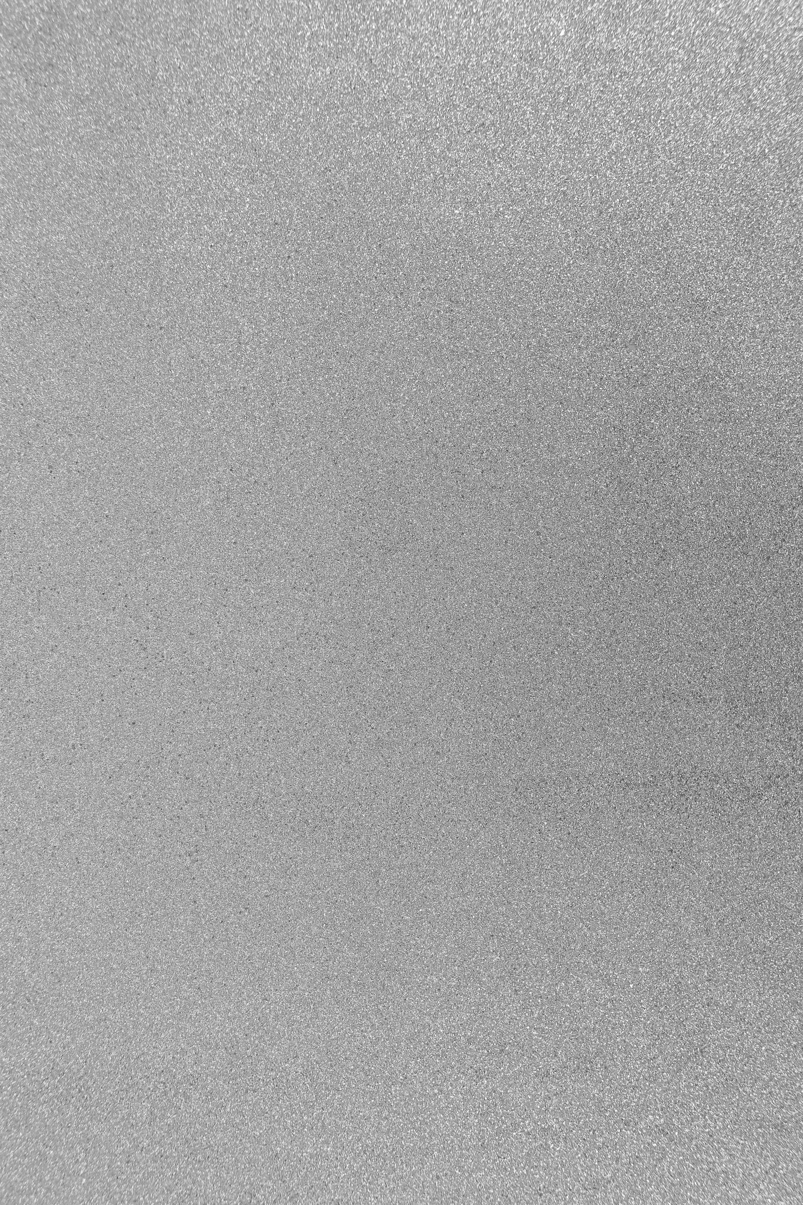 Macro shot of brushed titanium alloy surface showing fine grain texture